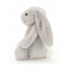 doudou lapin gris sur le coté